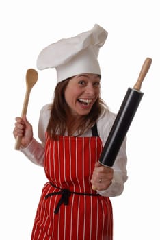 laughing attractive female chef, brandishing spoon & rolling pin, isolated on white - humorous concept