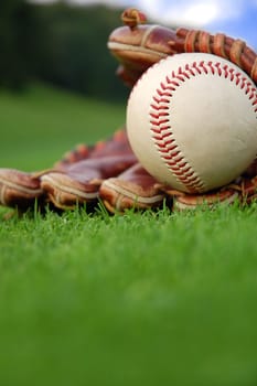 Close up of a baseball glove on the grass