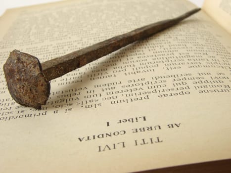 rusty ancient nail on the opened book