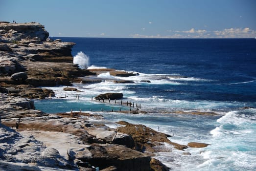 Ocean pool by coast with blue sky