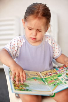 Cute child reading a picture book