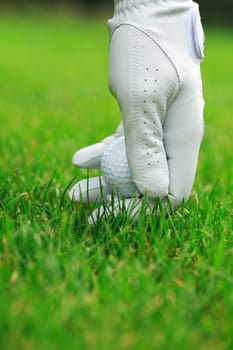 Detail of golf ball and gloves