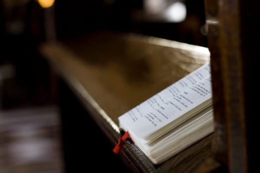 Praying book (bible) on a desk in a church.