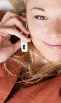 Businesswoman wearing red suit working using  mobile phone. Blong long hair.