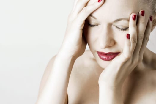 Beautiful sensual woman with headache/ pain. White background.