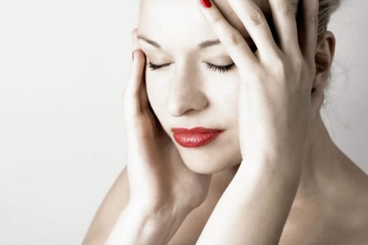 Beautiful sensual woman with headache/ pain. White background.