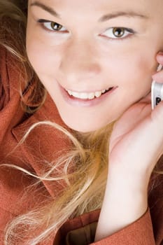 Businesswoman wearing red suit working using  mobile phone. Blong long hair.
