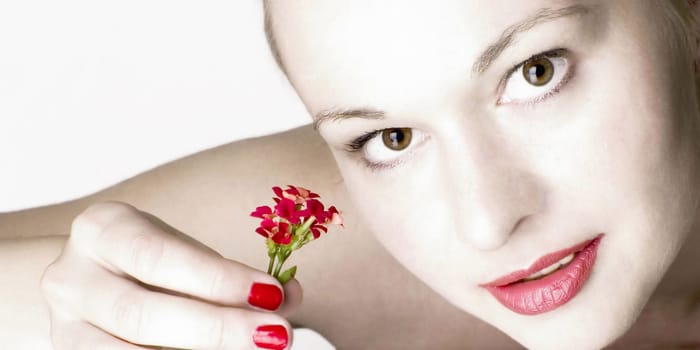 Beautiful woman with red flowers. White background.