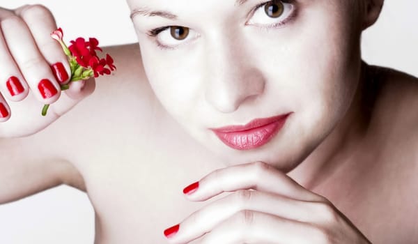 Beautiful woman with red flowers. White background.
