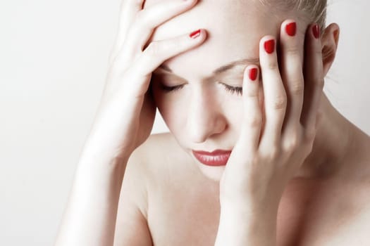 Beautiful sensual woman with headache/ pain. White background.