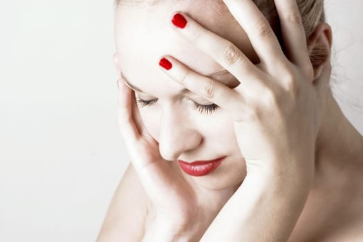 Beautiful sensual woman with headache/ pain. White background.
