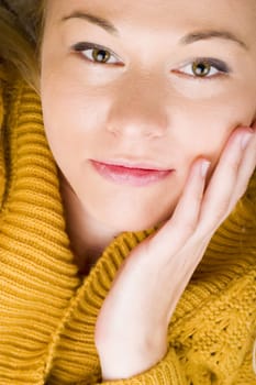 Beautiful young woman wearing yellow cardigan.