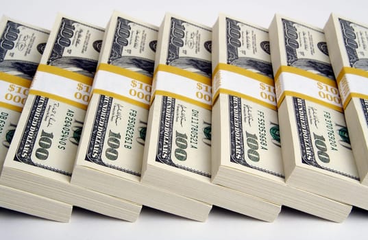 Stacks of One Hundred Dollar Bills on a white background