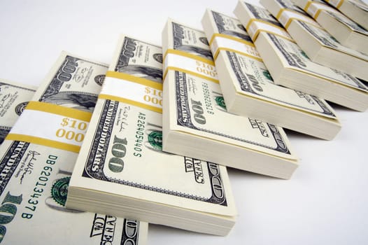 Stacks of One Hundred Dollar Bills on a white background