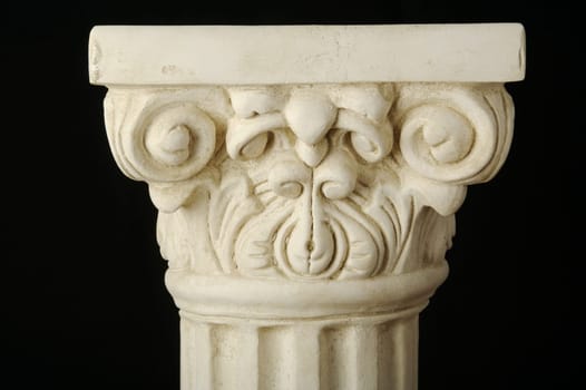 Ancient Column Pillar Replica on a Black Background.