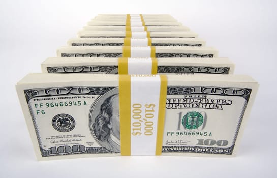 Stacks of One Hundred Dollar Bills on a white background