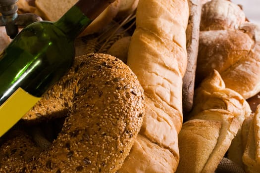 baked bread and a bottle of wine