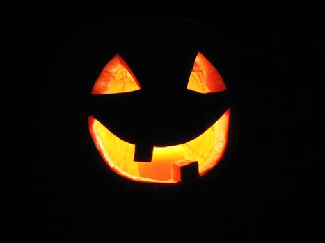 Lit Jack-o-lantern on black background