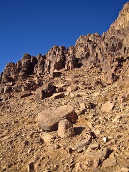 Greater mountain boulders laying on a background of the sky
