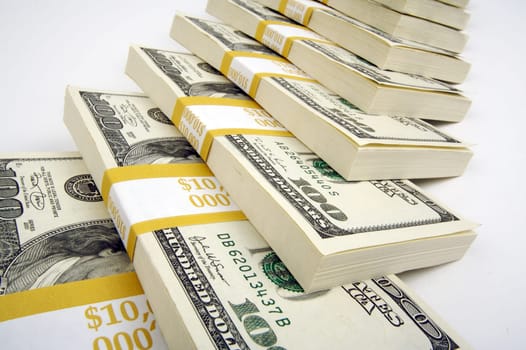 Stacks of One Hundred Dollar Bills on a white background