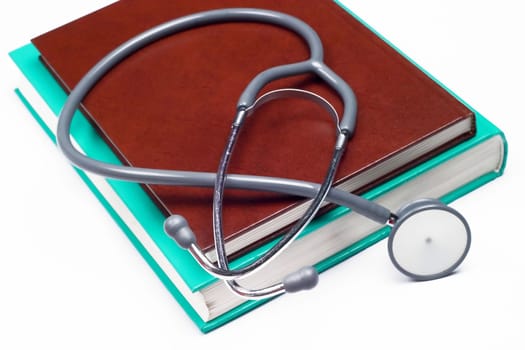 Stethoscope on a medical book isolated on white