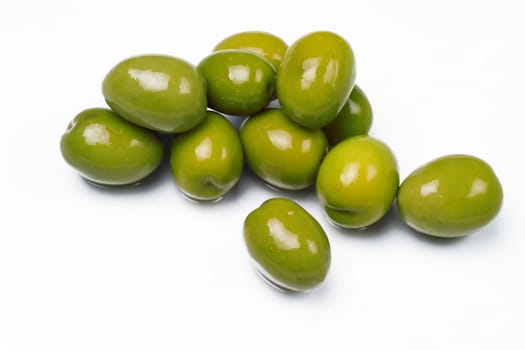 Green olives isolated on wet glass table