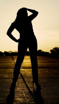 Afriscan American woman against a bright sky at sunset.
