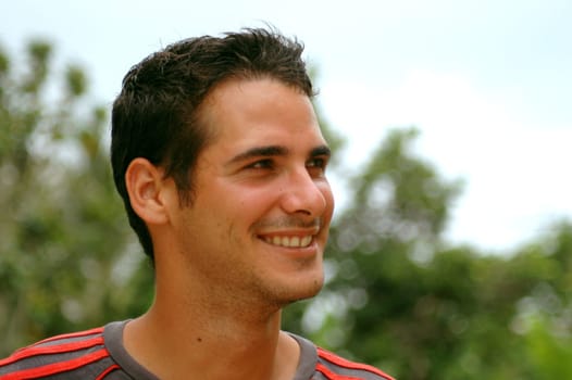 Portrait of young handsome boy smiling in natural atmosphere