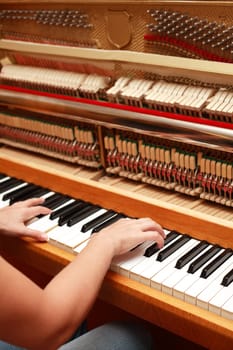 Detail of hands playing piano
