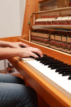 Detail of hands playing piano
