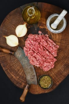 Making fresh raw beef mince meat with chopping knife, top view