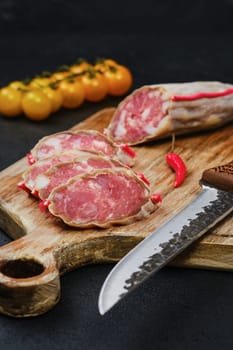 Slices of dry beef sausage on cutting board