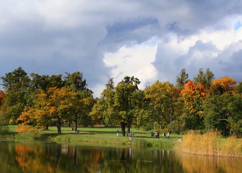 Picturesque autumn landscape of river and bright trees and bushes