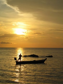 Fisherman casting his nets at sunset, Ko Lanta, Thailand