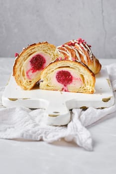 Croissant cut in half, showing the cross section with raspberry stuffing
