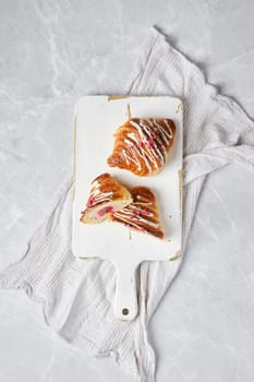 Top view of crispy croissant on wooden serving board