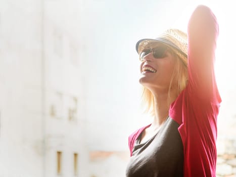 Young happy hipster woman tourist in casual fashion clothing and summer stylish hat traveling and enjoy the summer holiday in the city. Youth lifestyle concept. Retro style filter.