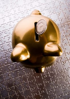 Piggy bank on jigsaws & on the colorfull background