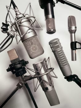 A series of recording studio microphones.  Slightly desaturated.