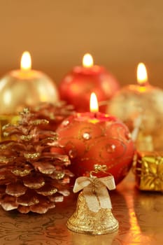 Beautiful Christmas candles in golden and red tones as decoration