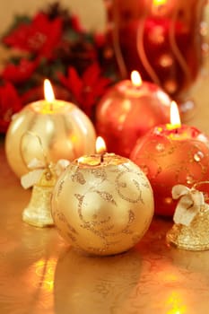 Beautiful Christmas candles in golden and red tones as decoration