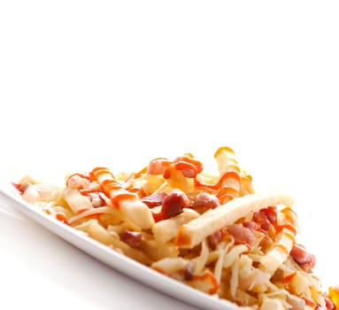 Tasty french fries served in plate. Potato chips with bacon and ketchup isolated on white background.