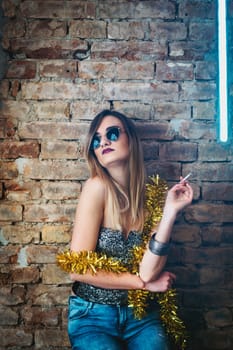 Young sexy woman having fun in discotheque. Happy fashion girl celebrating new year party event in nightclub.