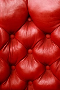 Background image of plush red leather from an antique seat.