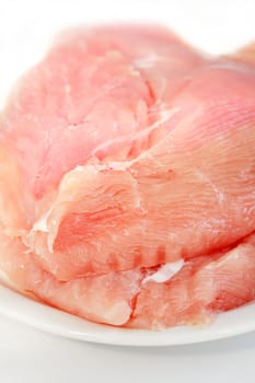 Raw turkey breast on the plate