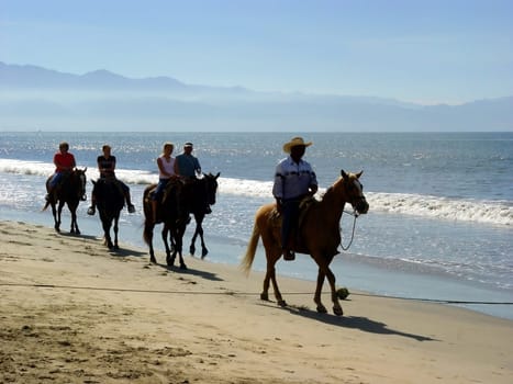Horseback riders at the beach