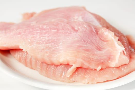 Raw turkey breast on the plate