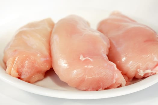 Raw chicken breast on the plate