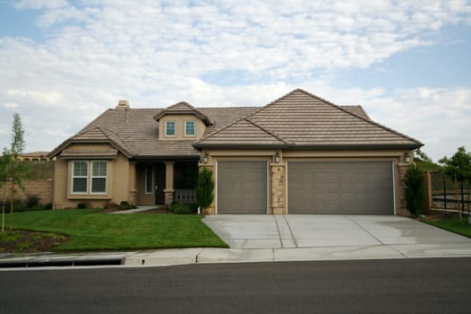 A newly constructed, modern american home with fresh landscaping.