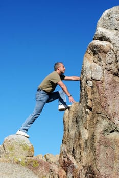 Man climbing to the top of the mountain